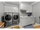 Well-equipped laundry room featuring a washer, dryer, cabinetry, and a sink at 4320 Blue Ridge Dr, Douglasville, GA 30135