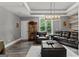 Living room featuring dark hardwood floors, large window, and leather sofas at 4320 Blue Ridge Dr, Douglasville, GA 30135