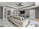 Elegant living room showcasing a modern sofa, stylish ceiling fan, and access to the luxurious bathroom at 4320 Blue Ridge Dr, Douglasville, GA 30135