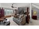 Cozy main bedroom with a four-poster bed, decorative couch, and ample natural light at 4320 Blue Ridge Dr, Douglasville, GA 30135