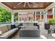 Cozy outdoor seating area featuring a stone fireplace, ceiling fan, and comfortable seating at 4320 Blue Ridge Dr, Douglasville, GA 30135