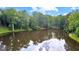 Backyard pond reflecting sky and mature trees at 4320 Blue Ridge Dr, Douglasville, GA 30135