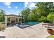 Beautiful backyard pool with lounge chairs, stone patio, and outdoor fireplace and seating under covered area at 4320 Blue Ridge Dr, Douglasville, GA 30135