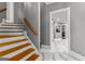 Wooden staircase with white risers and gray walls, leading to hallway at 4320 Blue Ridge Dr, Douglasville, GA 30135