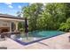 Stunning infinity pool overlooking lush trees, complete with a cozy outdoor lounging area at 4320 Blue Ridge Dr, Douglasville, GA 30135