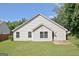 A well-maintained home exterior with green lawn and lush trees at 10690 Tara Village Way, Joneboro, GA 30238