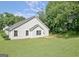 A well-maintained home exterior with green lawn and lush trees at 10690 Tara Village Way, Joneboro, GA 30238