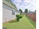 View of the fenced backyard with an outbuilding at 10690 Tara Village Way, Joneboro, GA 30238