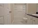 Bathroom with a shower-tub combo, modern toilet, and a vanity with a dark countertop at 10690 Tara Village Way, Joneboro, GA 30238