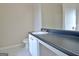 Bathroom with vanity featuring dark countertops and marble tile flooring at 10690 Tara Village Way, Joneboro, GA 30238