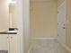 Bathroom sink vanity and doorway to outdoors with white tiling at 10690 Tara Village Way, Joneboro, GA 30238