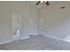 Open Primary bedroom with ensuite bathroom, a ceiling fan, and two windows at 10690 Tara Village Way, Joneboro, GA 30238