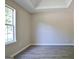 Bedroom featuring wood-look floors, a window with a view, and modern wall trim at 10690 Tara Village Way, Joneboro, GA 30238