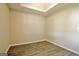 A bedroom has hardwood floors, neutral colored walls, and a tray ceiling at 10690 Tara Village Way, Joneboro, GA 30238