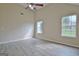 Vaulted ceiling bedroom featuring ceiling fan, hardwood floors, and natural light at 10690 Tara Village Way, Joneboro, GA 30238