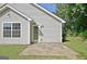 The exterior of the home has a door leading out to a patio with a lawn at 10690 Tara Village Way, Joneboro, GA 30238