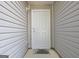 A close up of the white front door on the gray home at 10690 Tara Village Way, Joneboro, GA 30238