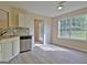 Bright kitchen with stainless steel dishwasher, granite countertops, and natural light at 10690 Tara Village Way, Joneboro, GA 30238