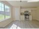 Well-lit kitchen with stainless steel appliances, tiled backsplash, and natural light at 10690 Tara Village Way, Joneboro, GA 30238