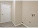 A laundry room has luxury vinyl plank floors, a white door, and is painted a neutral color at 10690 Tara Village Way, Joneboro, GA 30238
