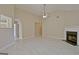 Spacious living room with vaulted ceiling, fireplace, and light-colored tile flooring at 10690 Tara Village Way, Joneboro, GA 30238