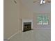 Comfortable living room featuring a fireplace and bright natural light from the window at 10690 Tara Village Way, Joneboro, GA 30238
