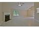 Spacious living room with a fireplace, tile flooring, and large window at 10690 Tara Village Way, Joneboro, GA 30238