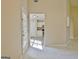 Bright living room features an entry to kitchen with white cabinets and stainless appliances at 10690 Tara Village Way, Joneboro, GA 30238
