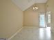 Bright living room featuring high ceilings, neutral walls, and sleek tile flooring at 10690 Tara Village Way, Joneboro, GA 30238