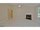 Open concept living room with tile floors, fireplace, and bright natural lighting at 10690 Tara Village Way, Joneboro, GA 30238