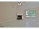 Bright, spacious living room featuring tile flooring, a fireplace, and large windows at 10690 Tara Village Way, Joneboro, GA 30238