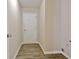 A mud room has luxury vinyl plank floors, a white door, and is painted a neutral color at 10690 Tara Village Way, Joneboro, GA 30238