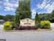 The community has a decorated 'The Village Attara' sign surrounded by shrubs and bushes at 10690 Tara Village Way, Joneboro, GA 30238