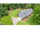 Aerial view of a home with a long driveway, lush landscaping, and mature trees at 145 Adams Ct, Fayetteville, GA 30214