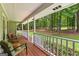 Inviting back porch with chairs, plants, and a view of the serene, wooded backyard at 145 Adams Ct, Fayetteville, GA 30214