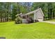 A spacious backyard view, complete with mature landscaping, a deck, and an attached garage at 145 Adams Ct, Fayetteville, GA 30214