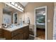 A calming bathroom features a wood-grain vanity and a large mirror, creating a spa-like retreat at 145 Adams Ct, Fayetteville, GA 30214