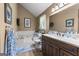 Spacious bathroom with a soaking tub, vanity with a countertop sink, and neutral decor at 145 Adams Ct, Fayetteville, GA 30214