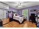 Comfortable bedroom featuring hardwood floors, ceiling fan, a window, and a bed at 145 Adams Ct, Fayetteville, GA 30214