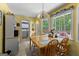 Sunny breakfast nook with wood table, chairs, and a view of the landscaped outdoors at 145 Adams Ct, Fayetteville, GA 30214