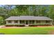 Charming single-story home with a well-manicured lawn and inviting front porch at 145 Adams Ct, Fayetteville, GA 30214