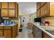 Efficient kitchen with wood cabinets, stainless steel dishwasher, and adjacent breakfast nook at 145 Adams Ct, Fayetteville, GA 30214