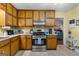 Practical kitchen featuring wooden cabinets, modern gas range, and durable countertops at 145 Adams Ct, Fayetteville, GA 30214