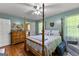 Inviting bedroom with a four-poster bed, dresser, and hardwood floors at 145 Adams Ct, Fayetteville, GA 30214