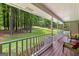 Enjoy the peaceful view of the yard from the covered front porch with seating at 145 Adams Ct, Fayetteville, GA 30214