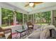 Cozy screened porch offering scenic views of a wooded backyard and a red wood shed at 145 Adams Ct, Fayetteville, GA 30214