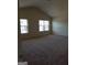 Spacious carpeted bedroom with two windows offering natural light and neutral wall paint at 556 Emporia Loop, Mcdonough, GA 30253