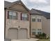 Traditional two-story home with a brick and siding exterior, attached two-car garage, and classic architectural details at 556 Emporia Loop, Mcdonough, GA 30253