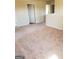 An empty hallway offers neutral-toned walls and carpet, a white door, and natural light streaming in at 556 Emporia Loop, Mcdonough, GA 30253