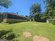 Grassy backyard with trees offering shade; screened-in porch visible, plus storage shed at 212 Hunting Court, Jonesboro, GA 30236